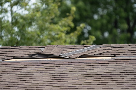 What wind damage looks like on shingle roofs and when it becomes a claim